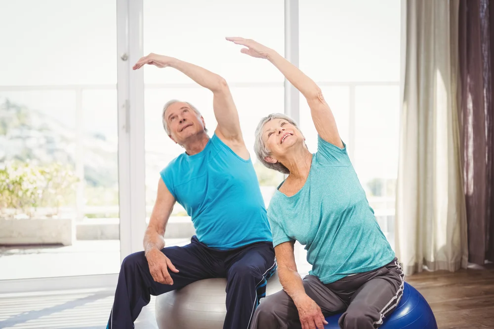 Seniors performing stretching exercises in a retirement community