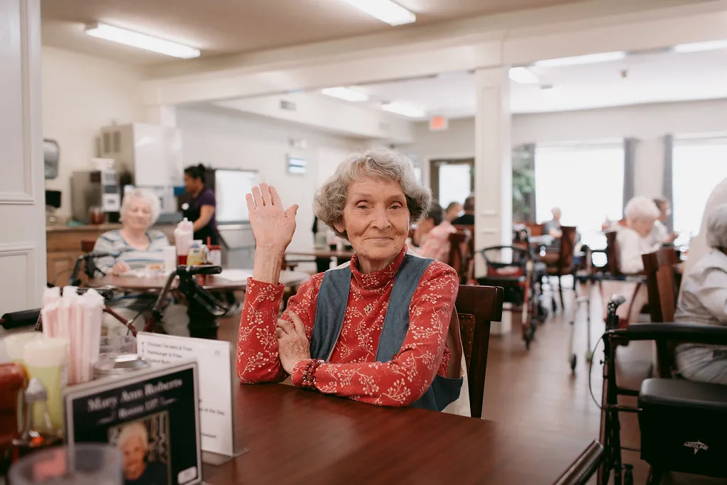 Residents talking together in a common area at Heritage Assisted Living